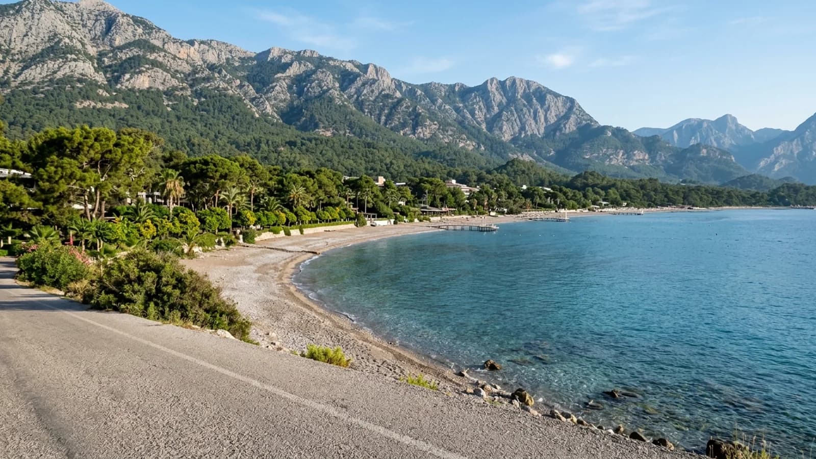 A Kemer taxi transfer brings you to this quiet pebble shore in Kiriş with pine gardens and calm clear sea.
