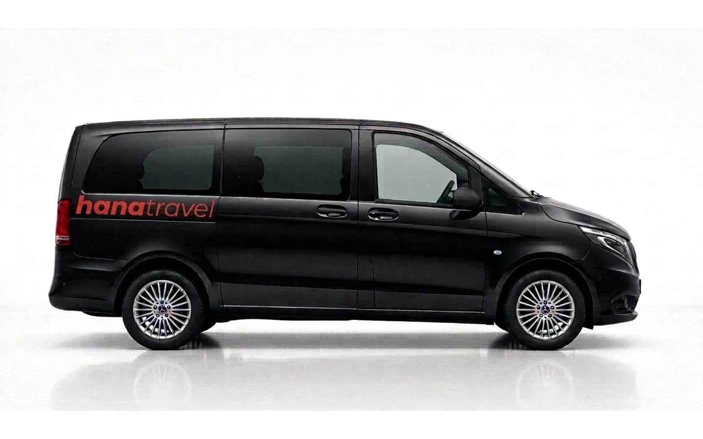 A black Mercedes-Benz Vito on a white background, suitable for a Kemer taxi transfer with six passengers and suitcases.